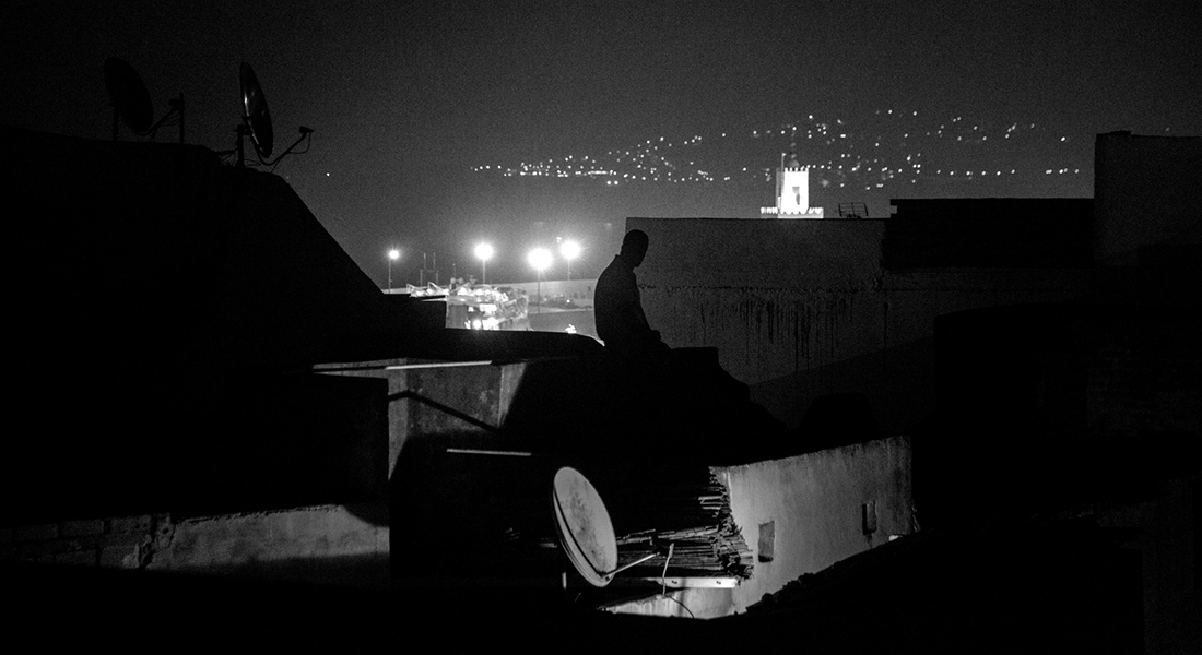 Man sitting alone in the dark. Photo: Christian Vium
